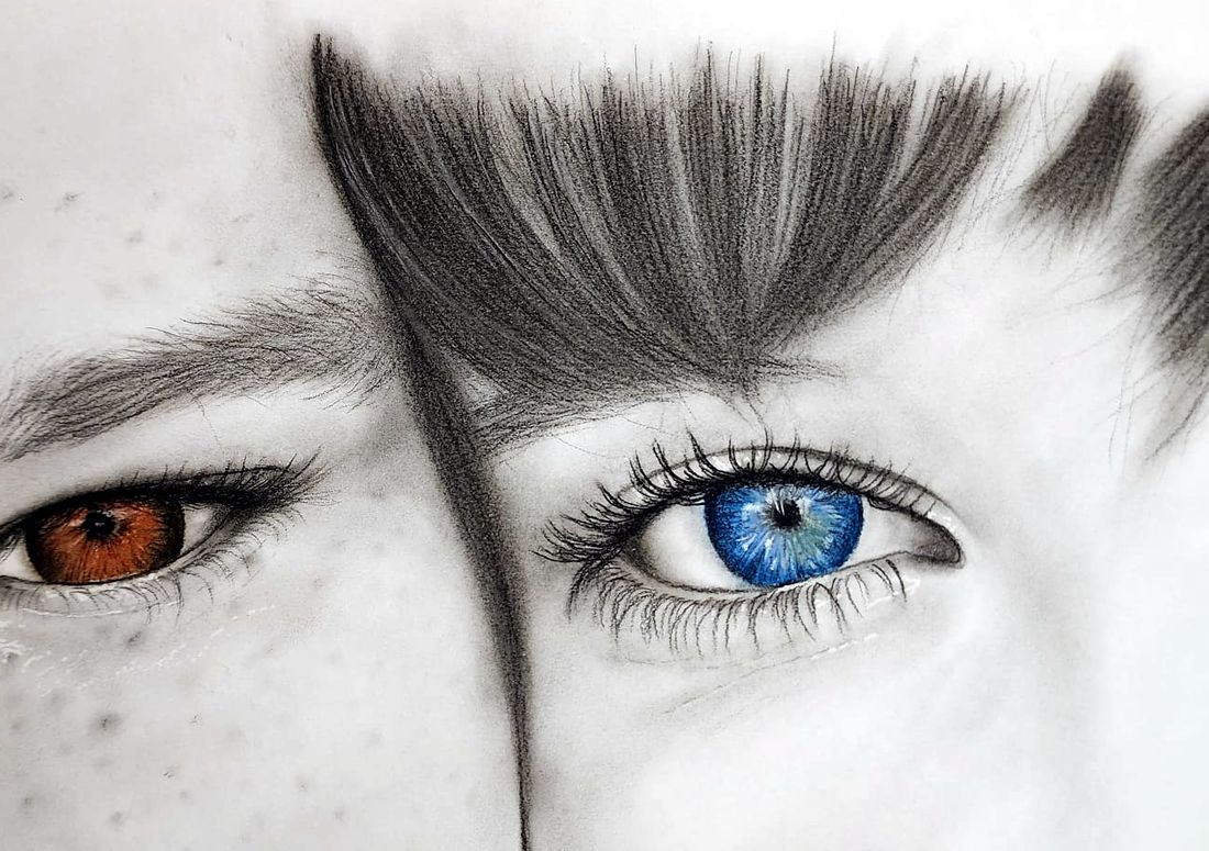 Drawing of two eyes, one brown and one blue, in graphite with colored irises